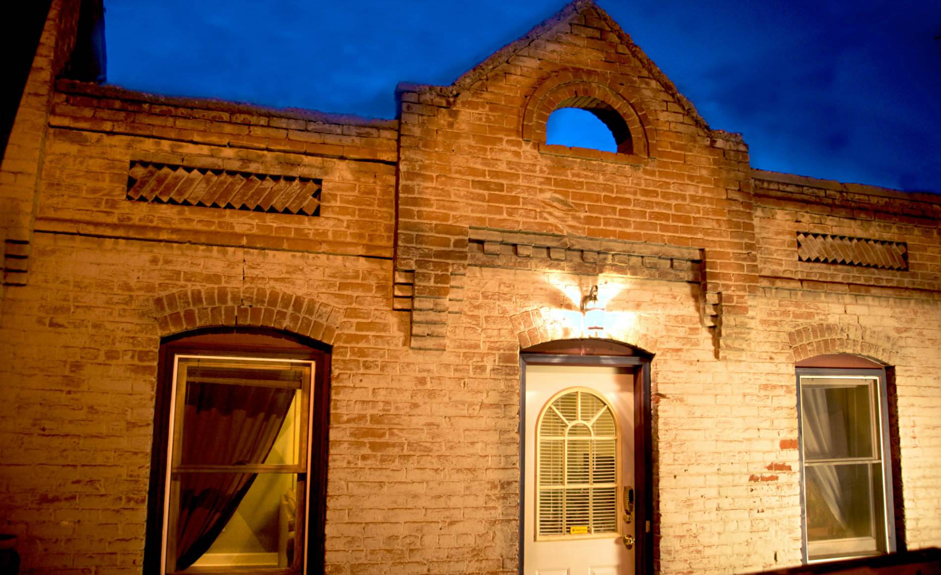 Picture of a brick buliding with a white door.