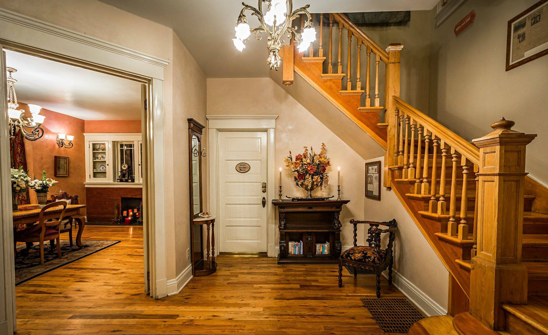 View of staircase with landing, and glimpse into dining area.